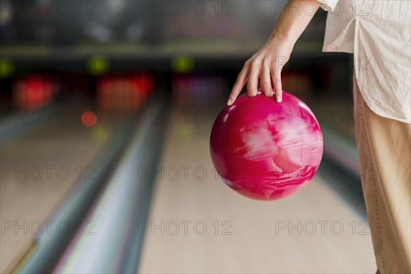 Person holding red bowling ball