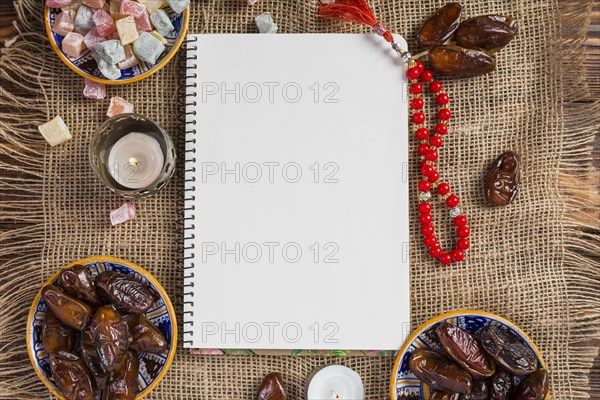 Turkish bowl juicy dates delight lukum with blank white page red holy beads jute cloth