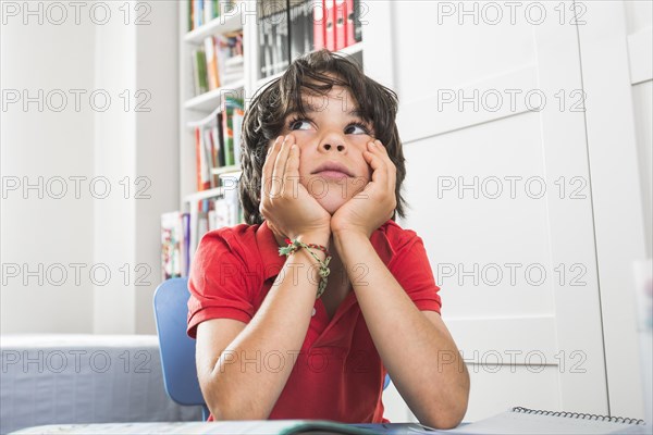 Cute kid sitting thinking