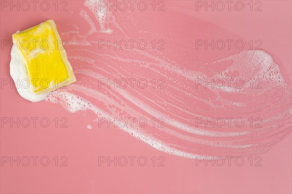 Top view sponge with foam pink background