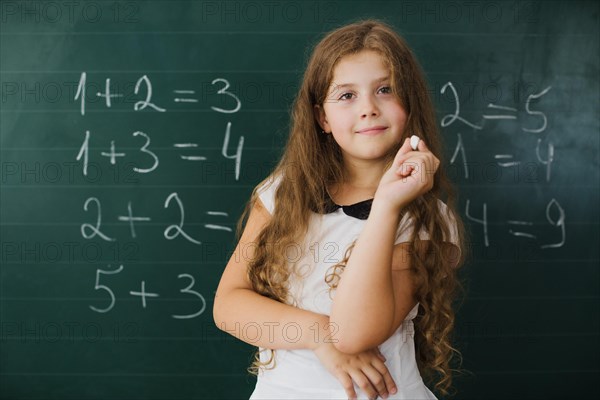 Schoolgirl smiling blackboard class