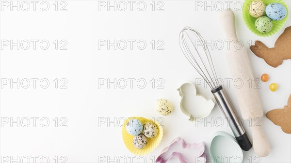 Top view colorful eggs kitchen utensils with copy space