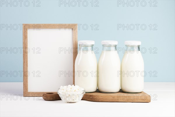 Wooden frame with bottles milk