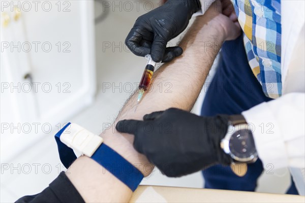 Nurse drawing blood from patient