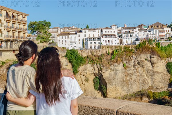 Tourist couple hugging admiring the city of ronda