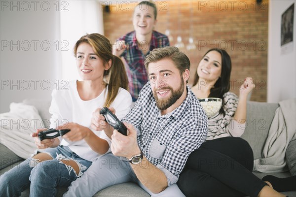 Expressive friends playing game sofa