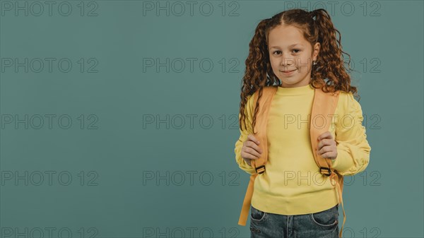 School girl with yellow shirt copy space
