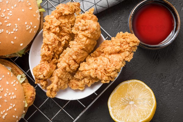 Top view fried chicken burgers tray with sauce lemon