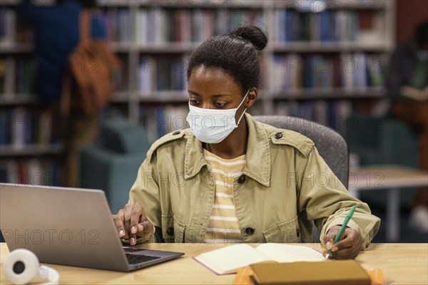 Student wearing face masks library