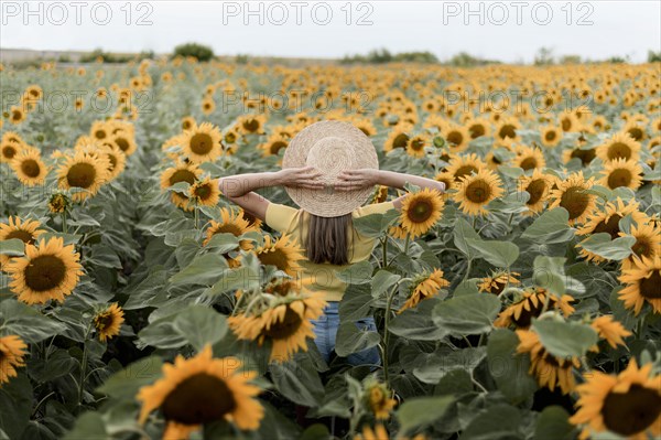 Back view woman wearing hat outdoors