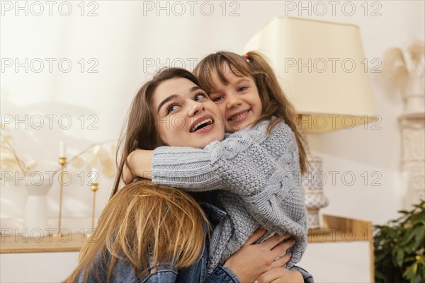 Mother daughter home hugging