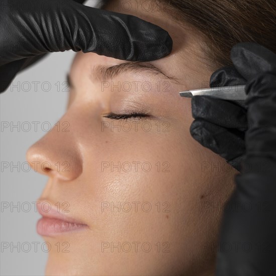 Close up woman getting her eyebrows done