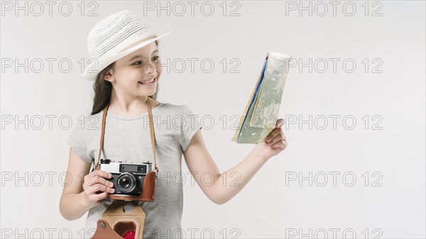 Junior traveler with map camera