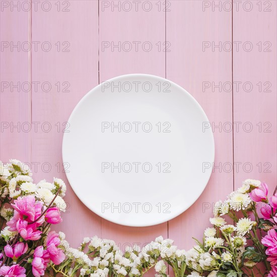 Pretty flowers near plate