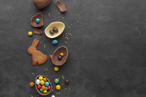 Top view chocolate easter egg with candy bunny shaped cookie