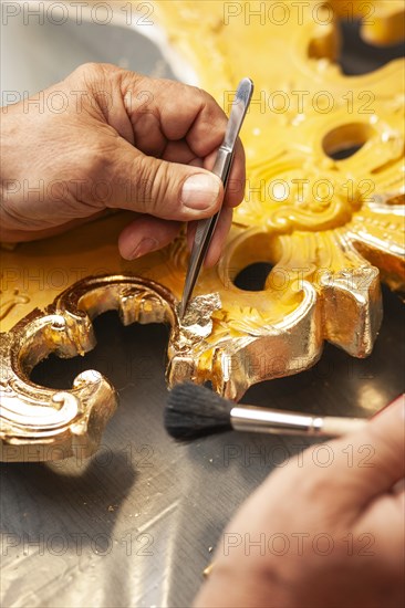 Detail of a mirror gilded with gold leaf