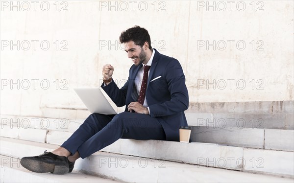 Full shot sitting man expressing victory