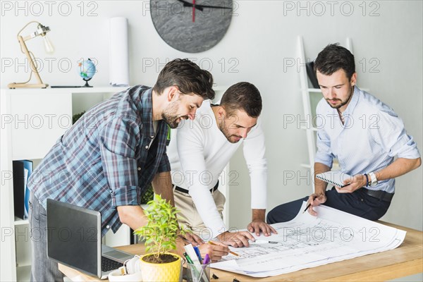 Group male architect preparing blueprint office