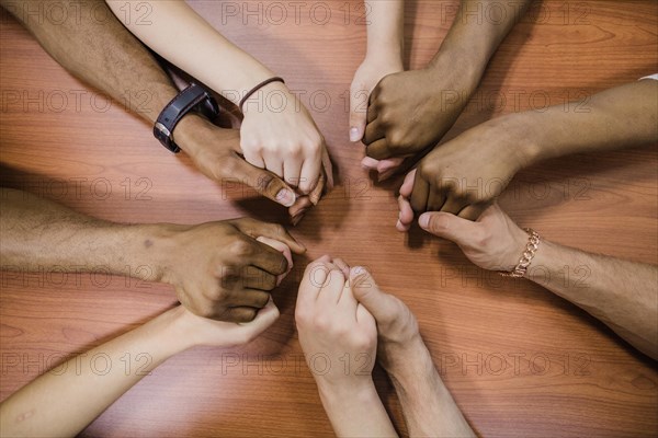 People holding hands table