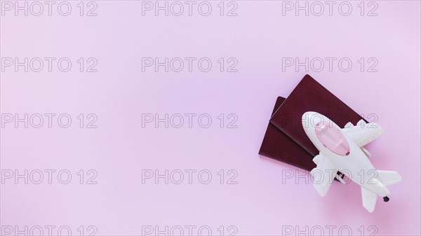 High angle view airplane passport pink surface