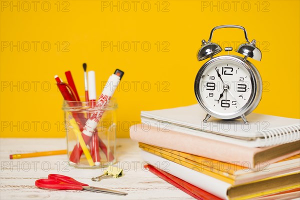 Back school concept clock pile books