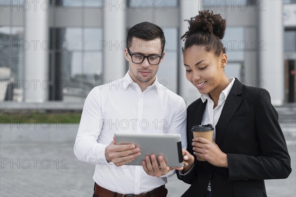 Man showing ipad colleague