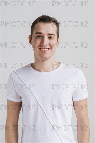 Smiling man white t shirt looking camera