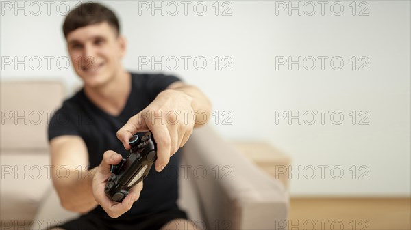 Front view blurred boy playing with controller