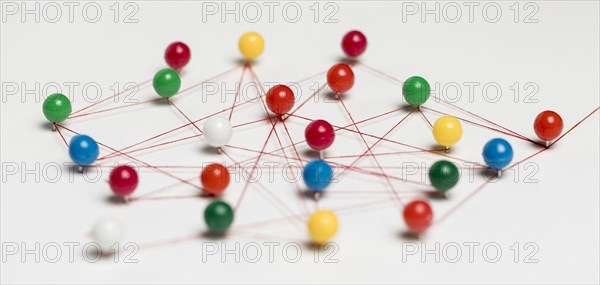 Colourful pushpins with thread route map