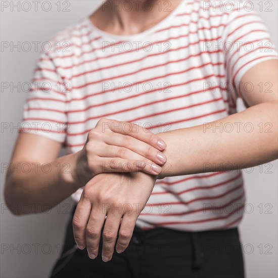 Mid section young woman having pain wrist