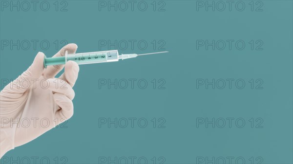 Syringe held by hand glove