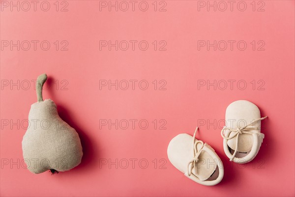 Stuffed pear fruit pair baby s shoes colored background
