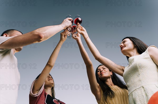 People toasting wine from