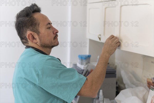 Latin doctor preparing to attend in his office