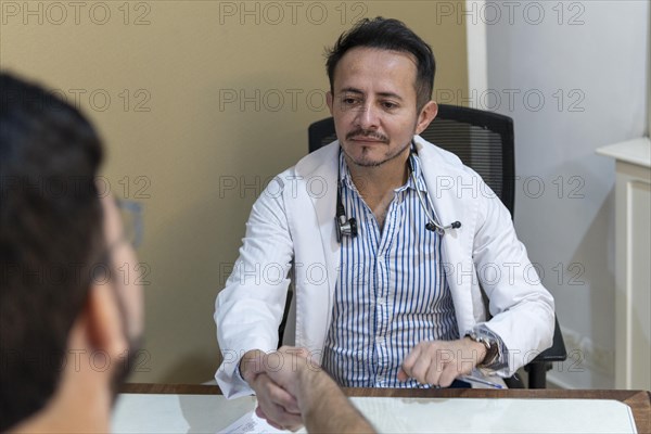 Latin doctor shaking hand to his patient