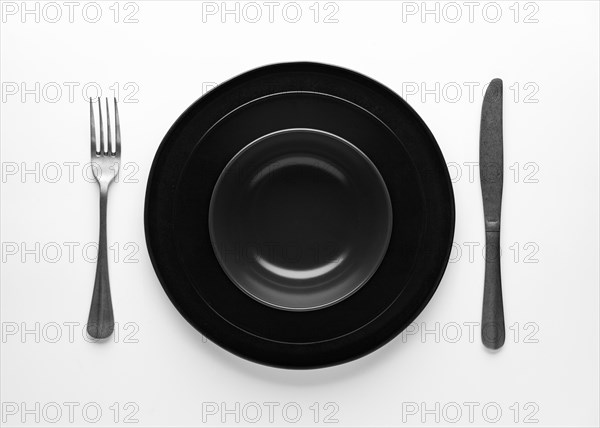 Flat lay dark dinnerware cutlery