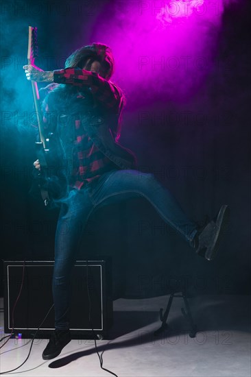 Artist playing guitar dancing