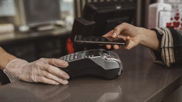 Close up customer paying her coffee bill