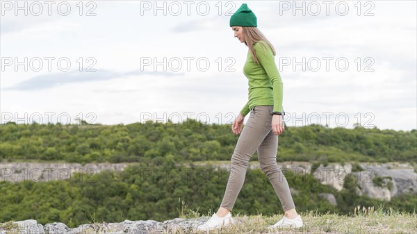 Side view young woman enjoying walking outdoors
