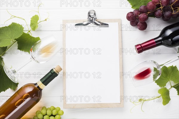 Clipboard mock up surrounded by wine bottles