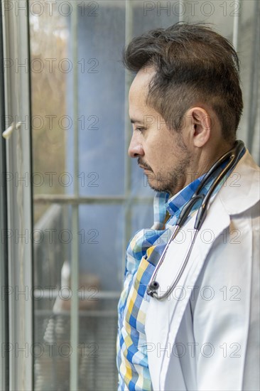Portrait of latin doctor posing in his office