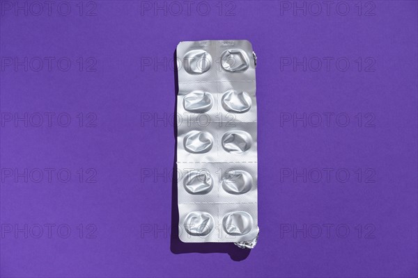 Empty tablet blister pack against a monochrome background