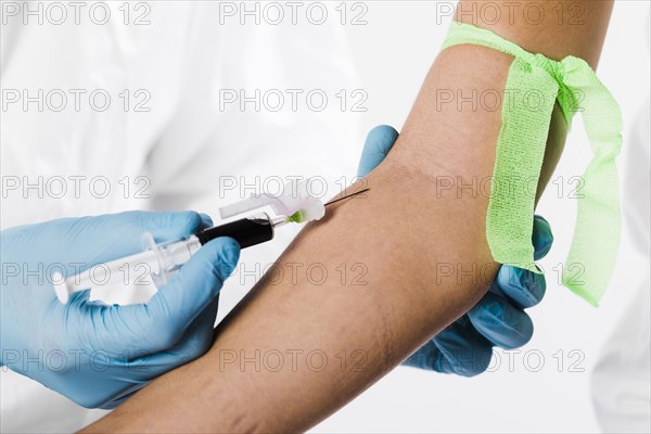 Doctor taking blood sample from sick person