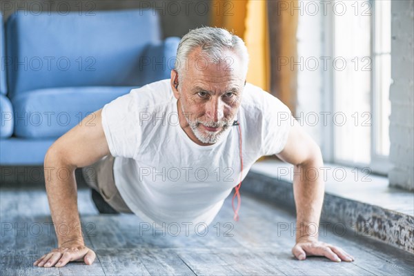 Senior man doing pushup home