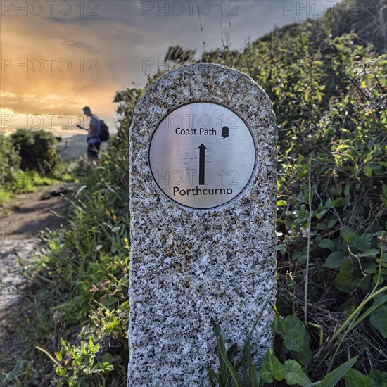 Walkers next to waymarker