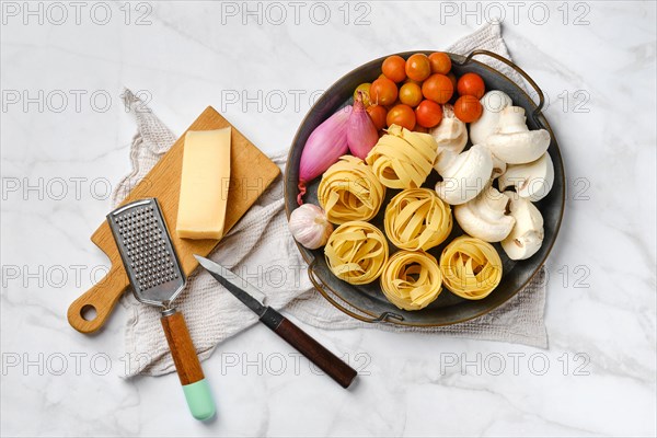 Metal tray with raw ingredients for mushroom pasta
