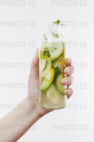 Hand with bottle fruit lemonade