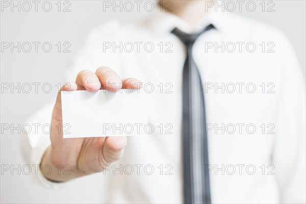 Human hand holding blank business card