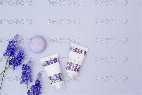 Fake lavender flower soap moisturizing cream colored background