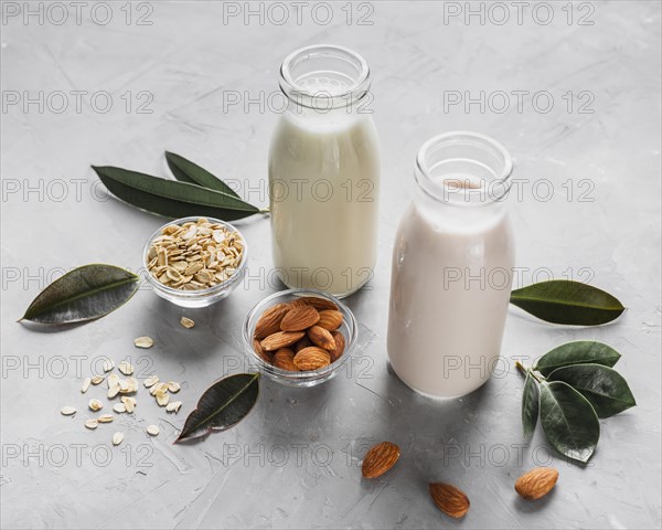 High angle milk bottles with almonds oats